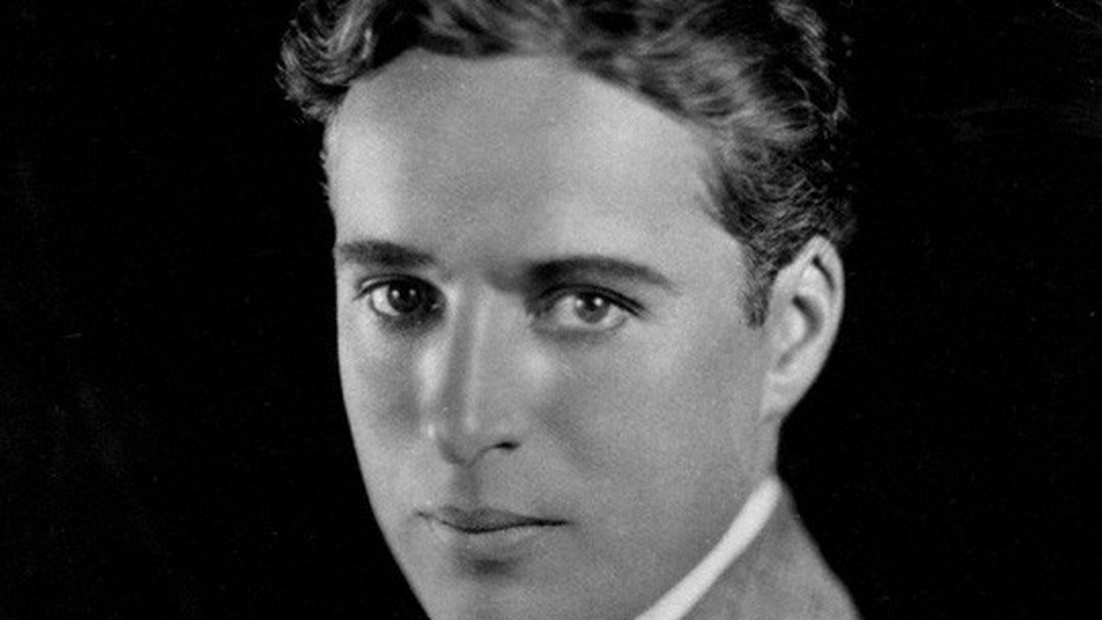 Studio portrait of Charlie Chaplin by Strauss-Peyton; not the 1952 Queen Elizabeth sailing