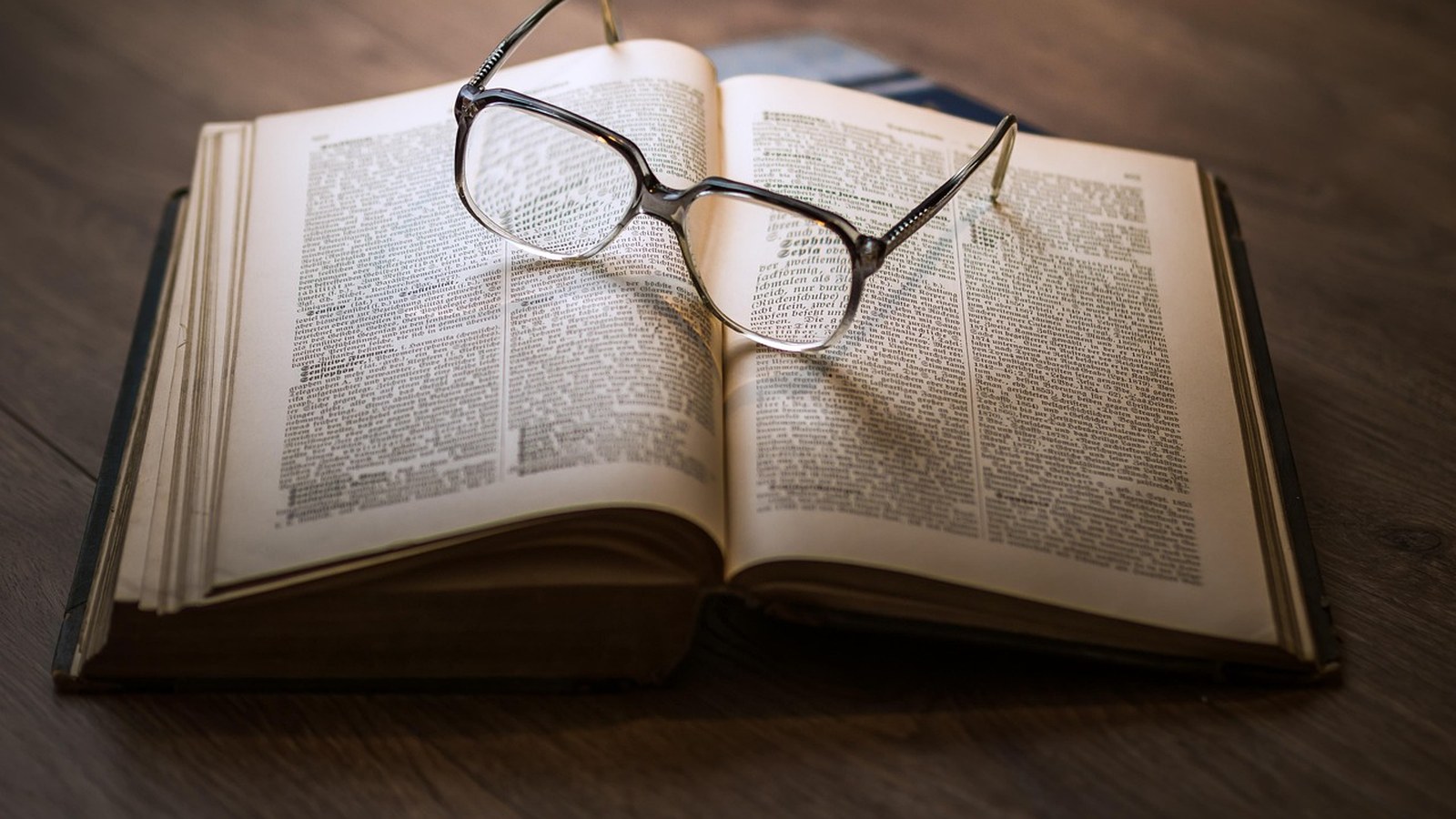 Open book on a desk, archive photograph associated with reading and literature