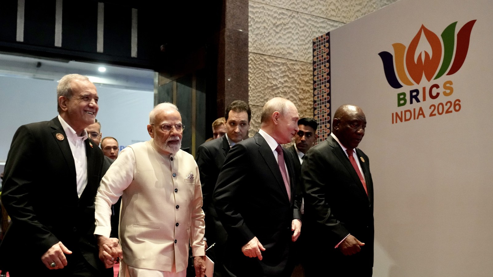Narendra Modi, Vladimir Putin, Cyril Ramaphosa and other BRICS leaders beside the BRICS India 2026 mark at Bharat Mandap…