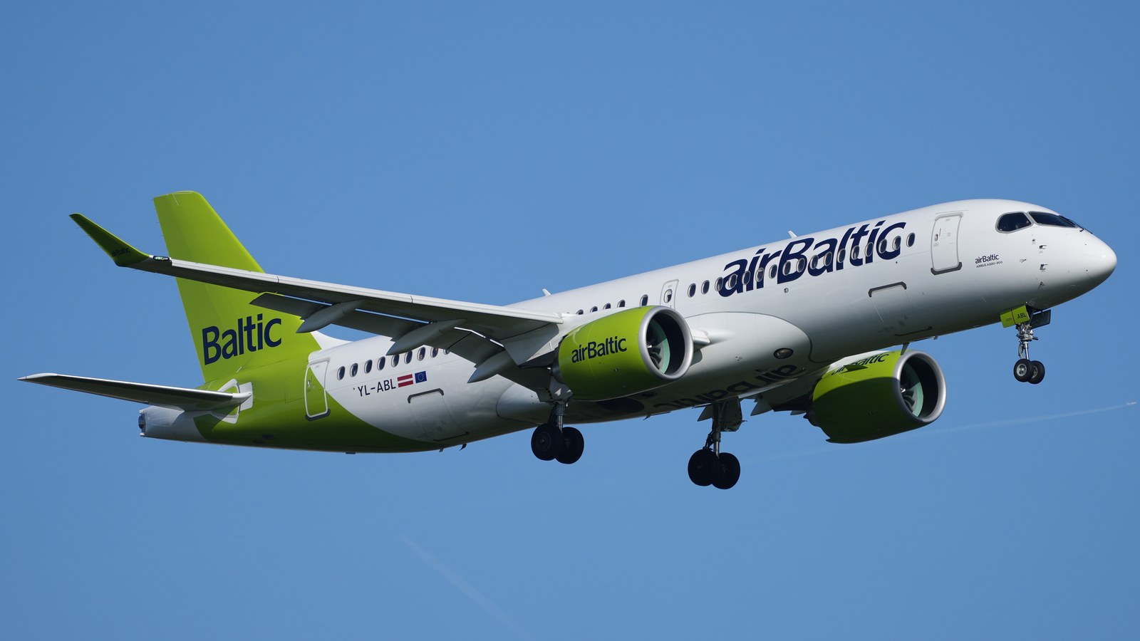 An airBaltic Airbus A220-300, registration YL-ABL, in flight over Frankfurt Airport